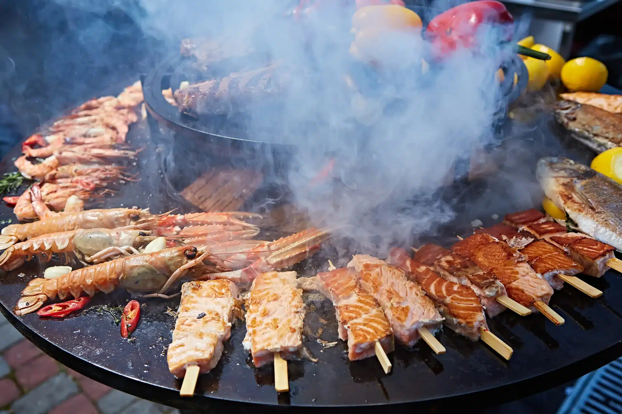 Grilled fresh seafood: prawns, fish, octopus, oysters food background Barbecue Cooking BBQ