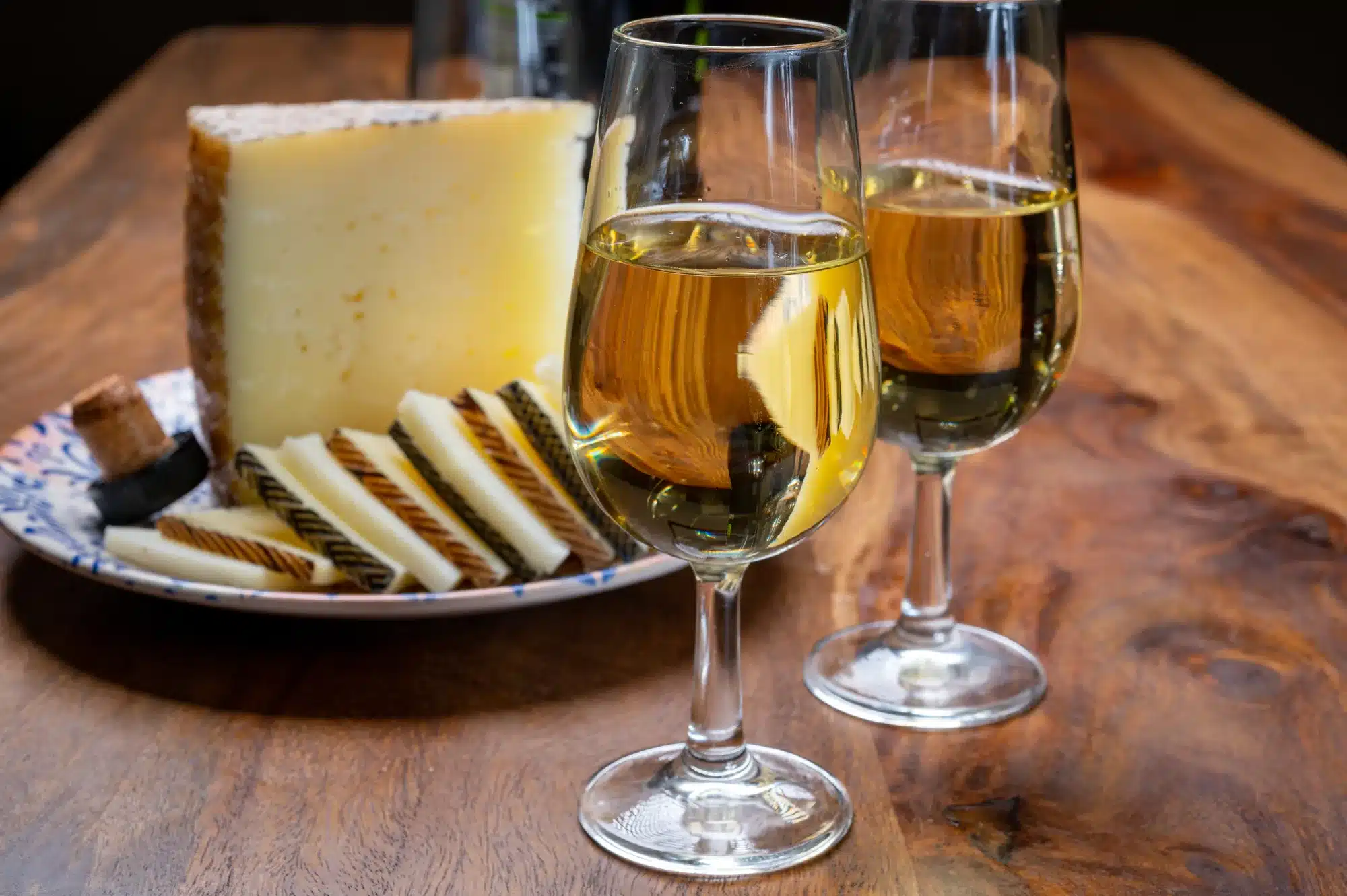 Spanish fino dry sherry wine from Andalusia and pieces of different sheep hard manchego cheeses made in La Mancha, Spain. Wine and cheese pairing