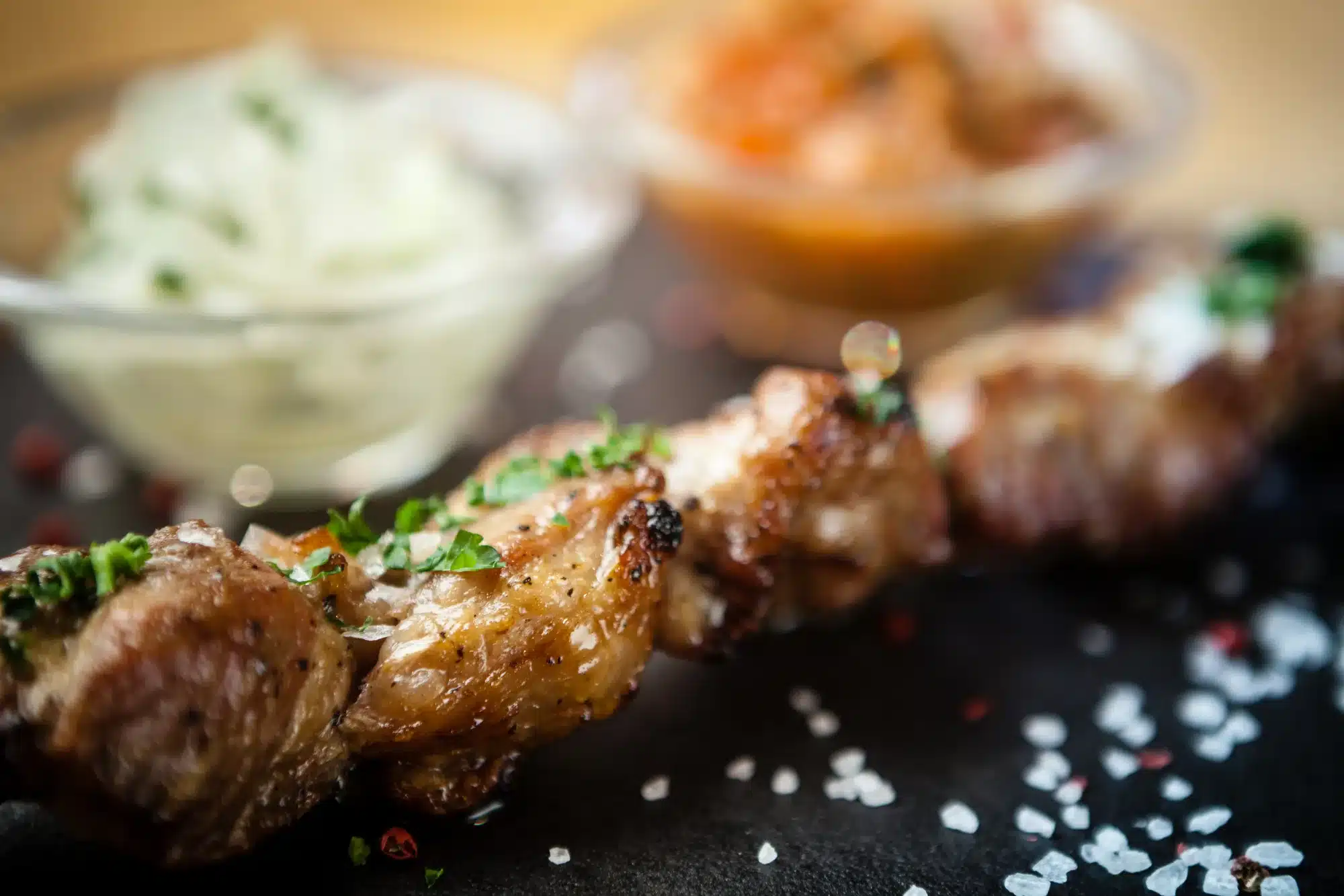 Iberian pork shish kebab with onion salad and sauce 