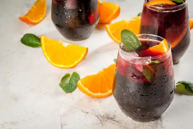 Traditional Spanish summer refreshing drink, cocktail, Tinto de Verano. With wine, ice and pieces of fresh orange.