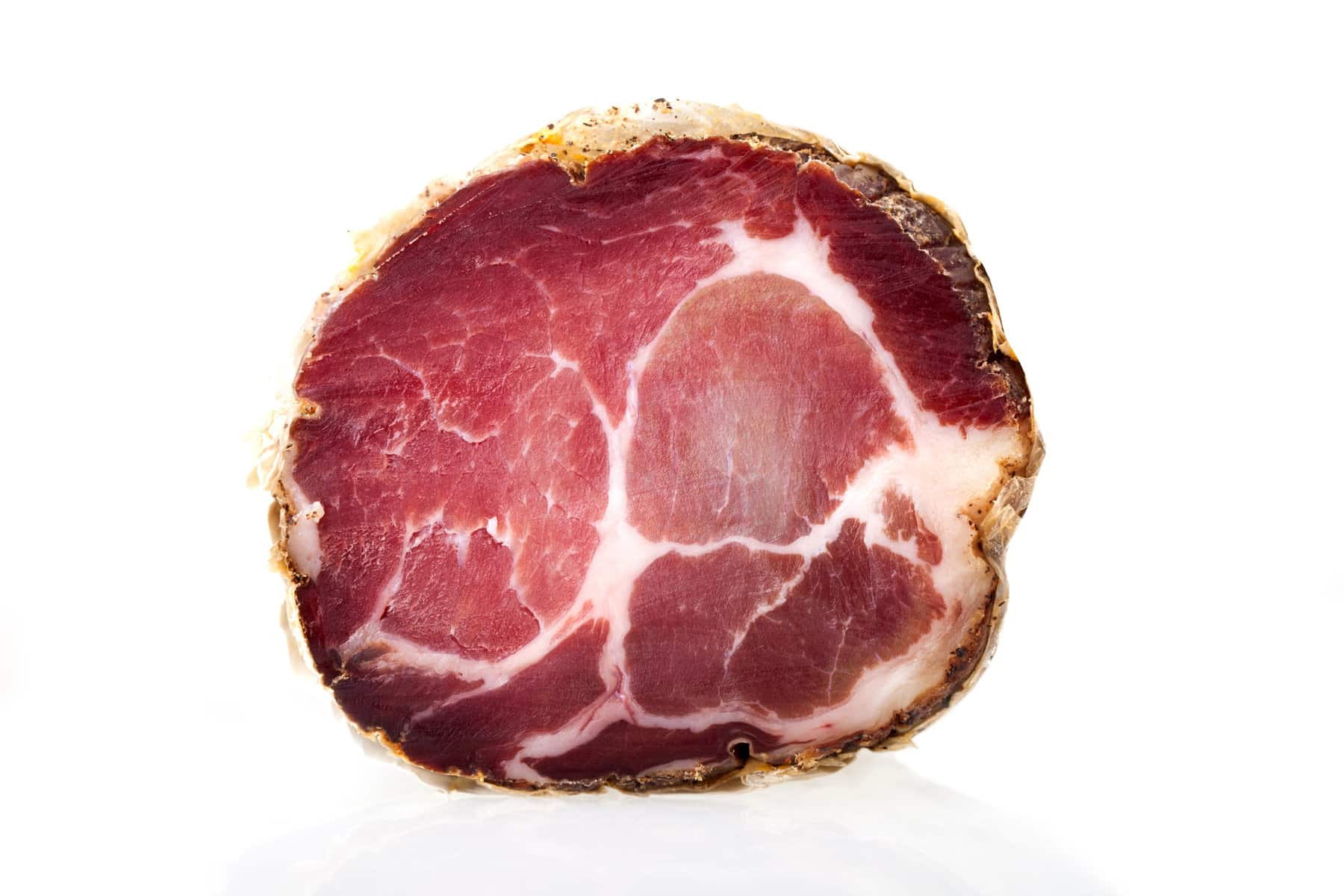 Coppa, Capocollo, Capicollo Cured ham on meat cleaver.