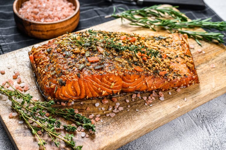 Hot smoked salmon fillet on a cutting Board. trout. Gray background, top view